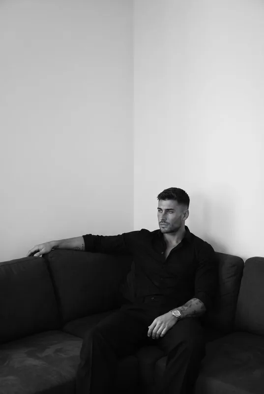 Ultra-realistic black-and-white casual photograph of the exact same adult man fr…