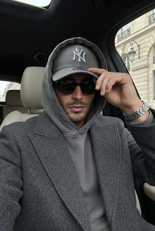 Preserve the reference person's identity and facial features; do not change the…
